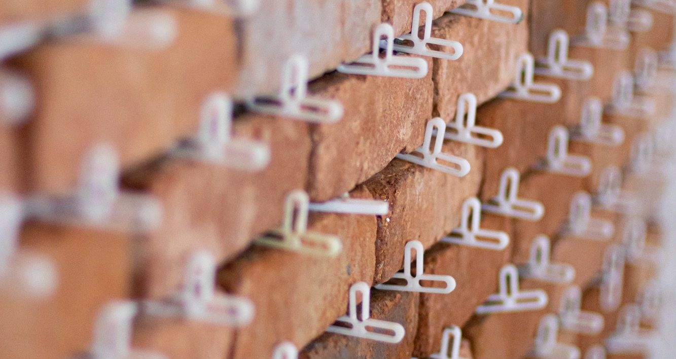 Brick slips with spacers during installation