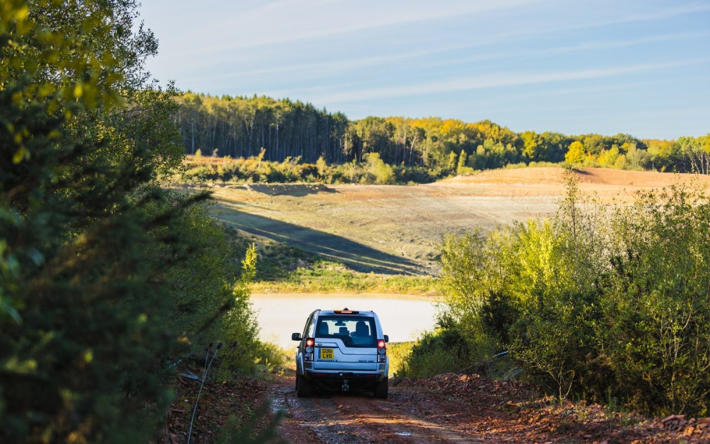 Land Rover driving through woodland site at Ewhurst
