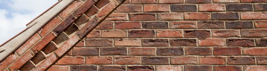 Close up of brickwork on roof gable end showing different brick bond patterns