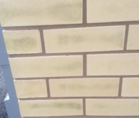 Green vanadium stains on buff brickwork