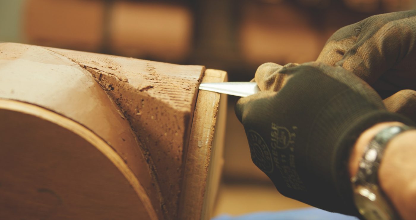 Hands carefully chiselling special shaped brick