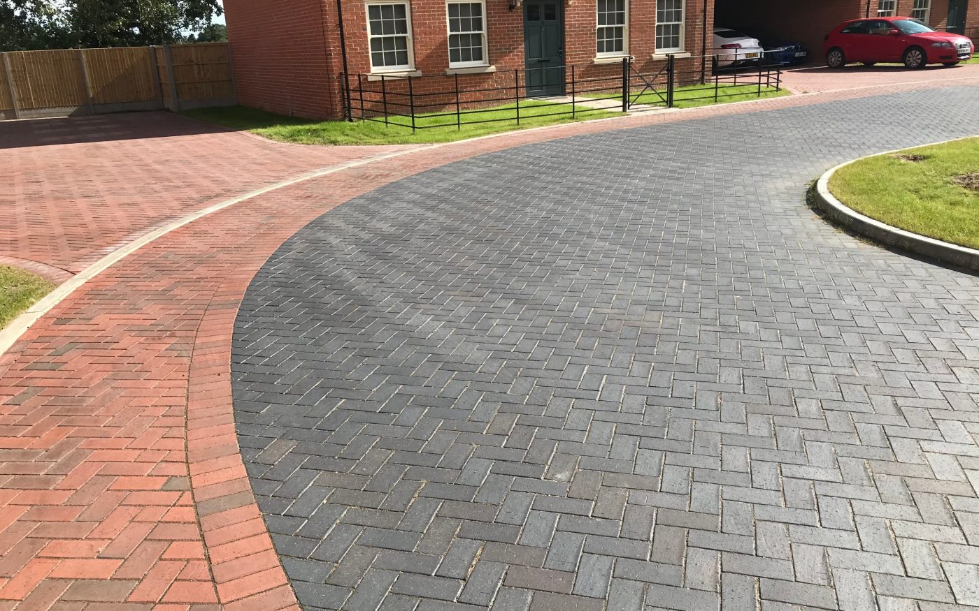 Red and grey/blue landscaped driveway on a new estate
