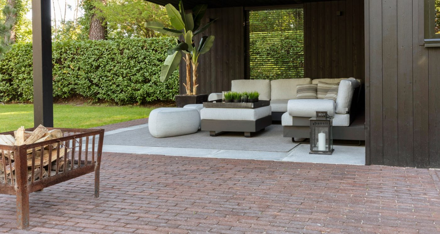 Landscaped modern area with outdoor sofa and fire pit