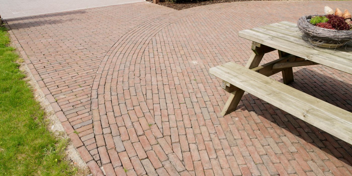 Circle created using clay pavers to produce a focal point for a picnic bench