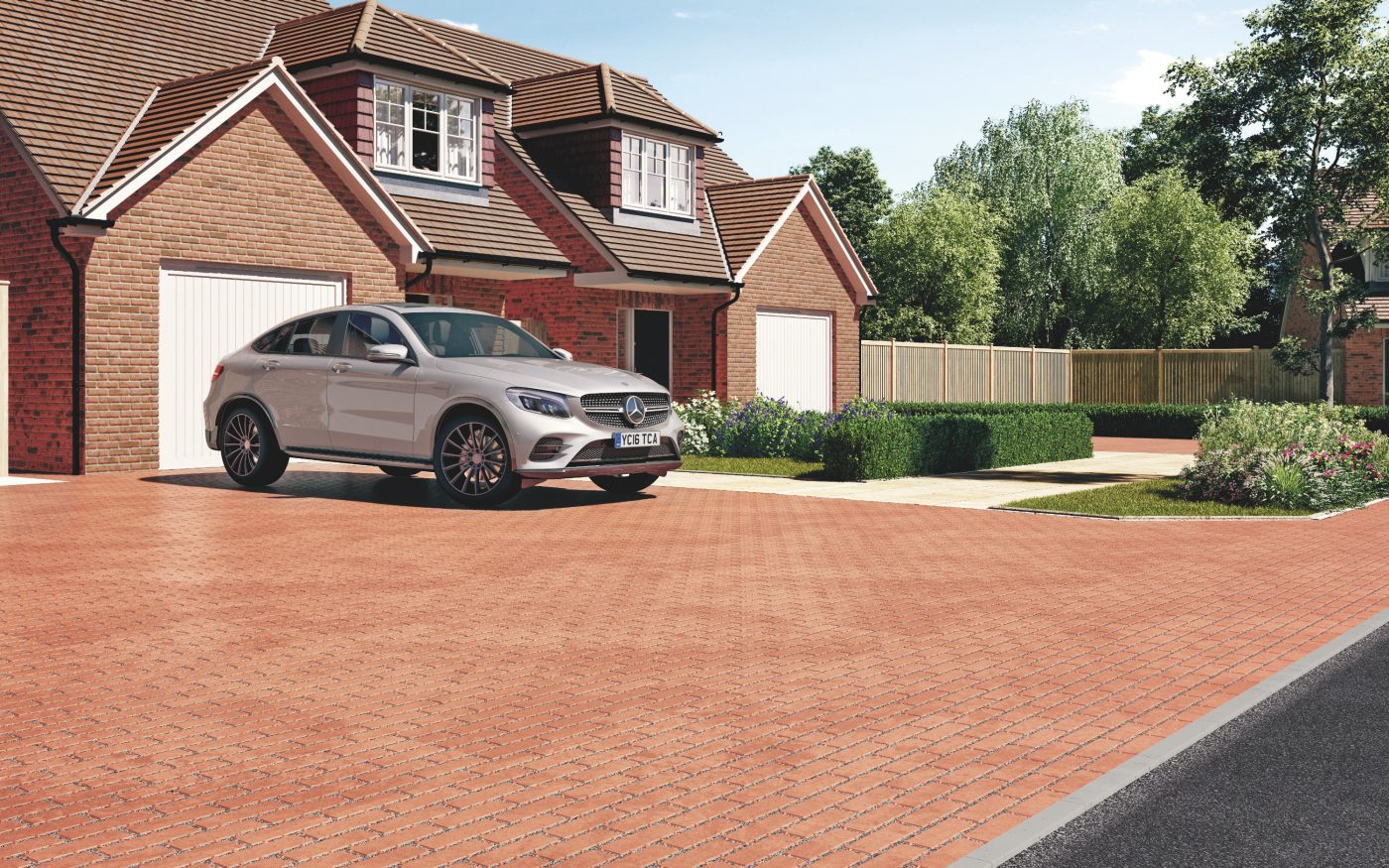 Car parked on a permeable driveway in front of modern house