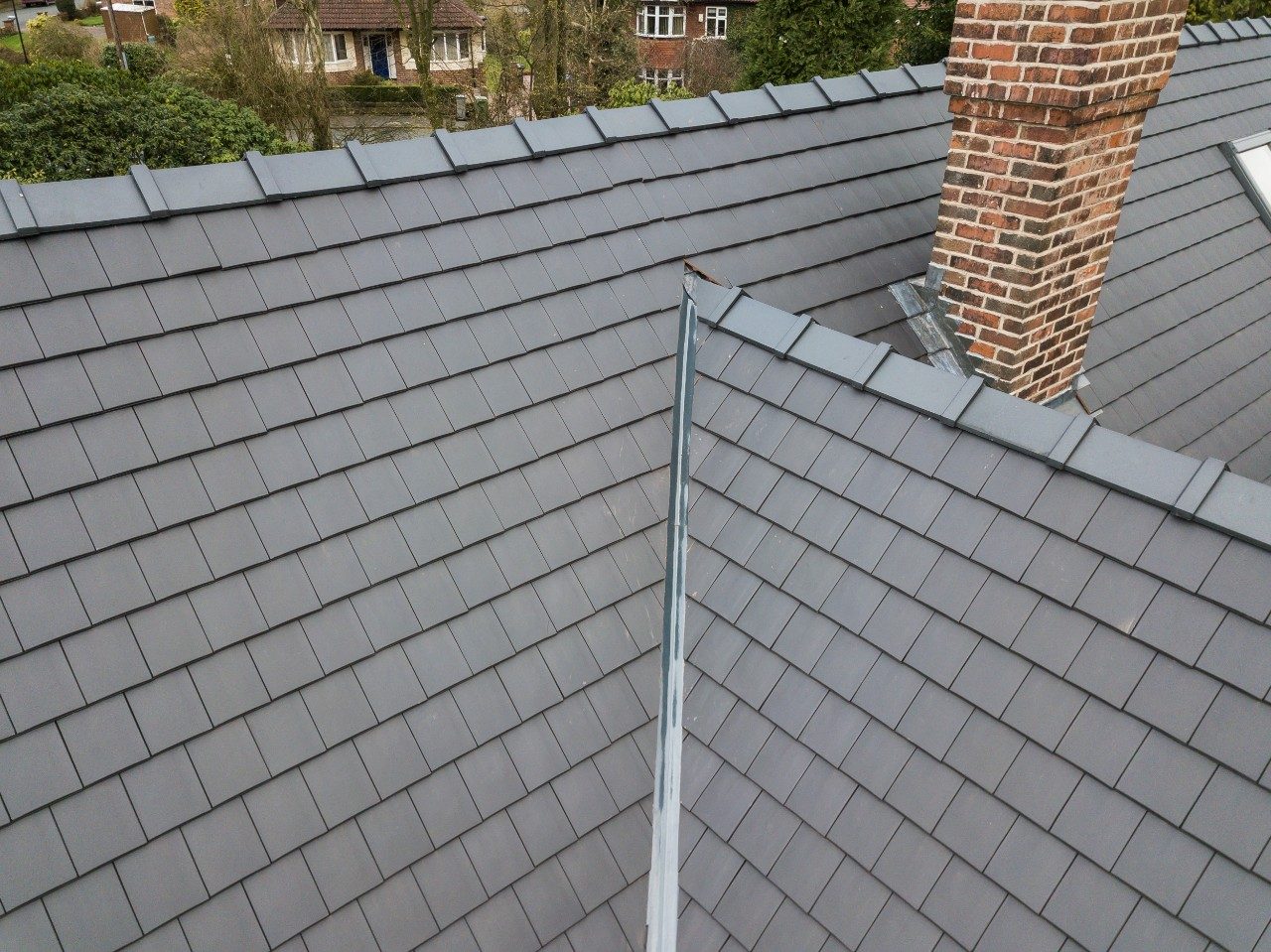 Modern roof tiles and brick chimney