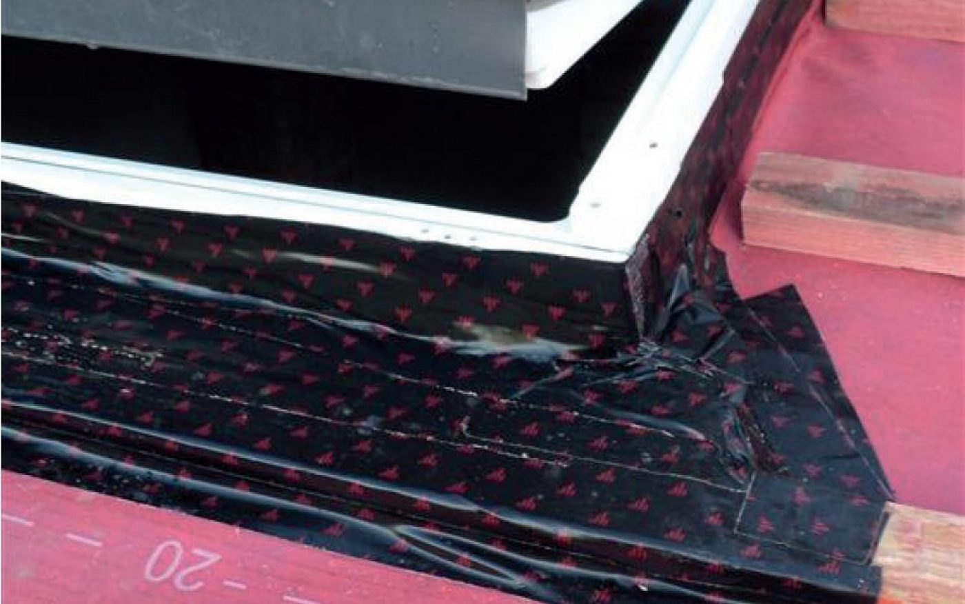 image showing underlay being taped around a fitted window in roof