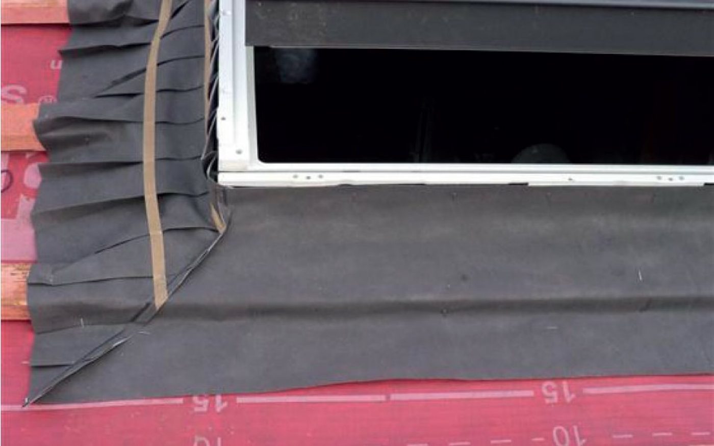 Image of a secondary underlay skirt being fit around a window
