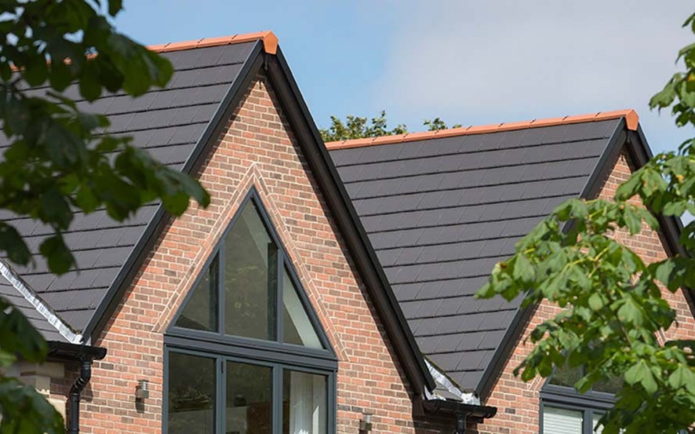 Brick homes with dark grey pitched roofs and gable windows