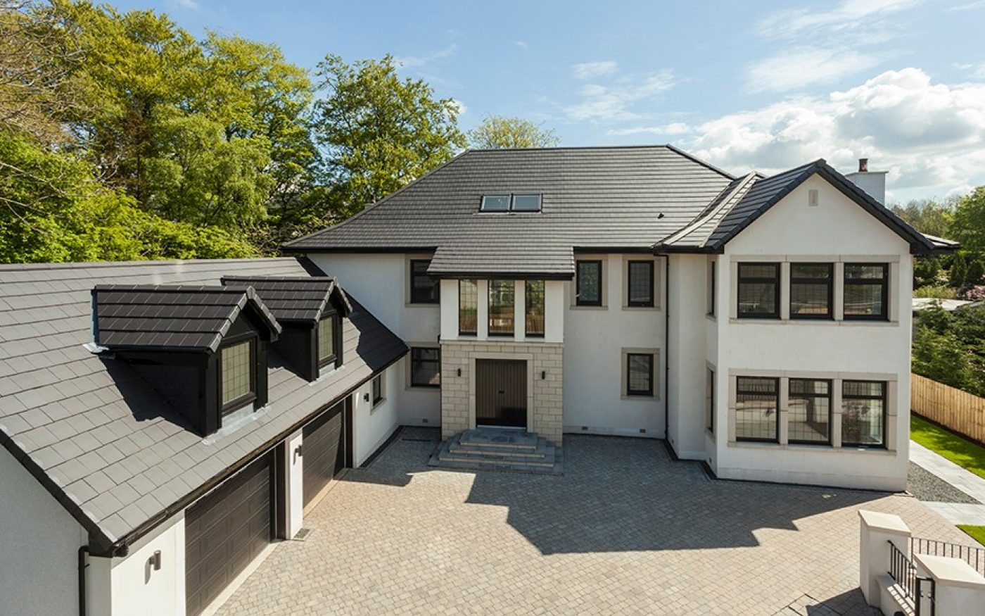 Large detached house with a grey tiled roof