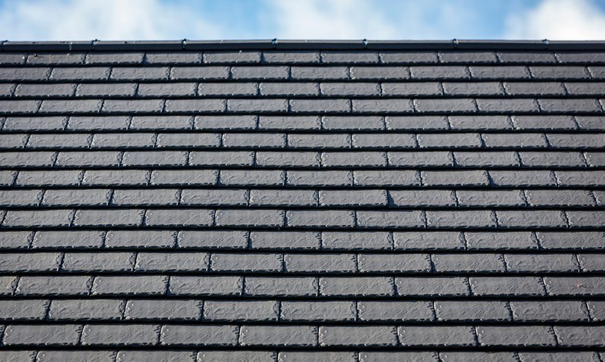close up of large grey roof tiles on a roof