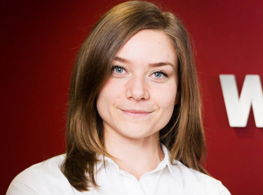 A landscape photo of Stephanie Palmer, UK Sustainability Manager with Wienerberger signage.