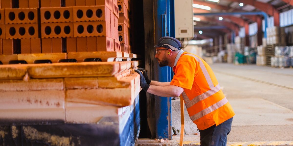 Man checking pallet of bricks in Ewhurst factory