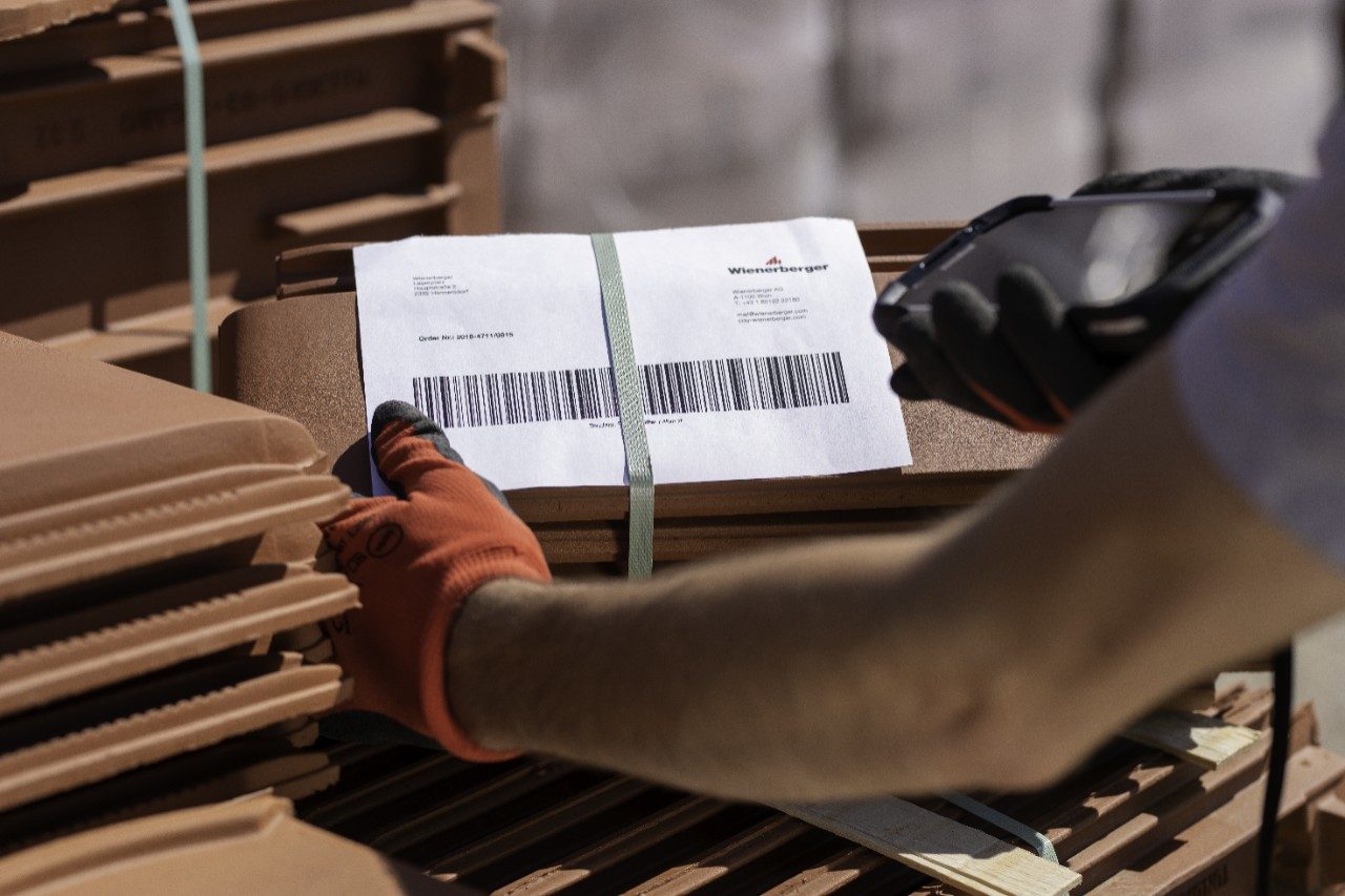 Stockyard employee scanning product codes